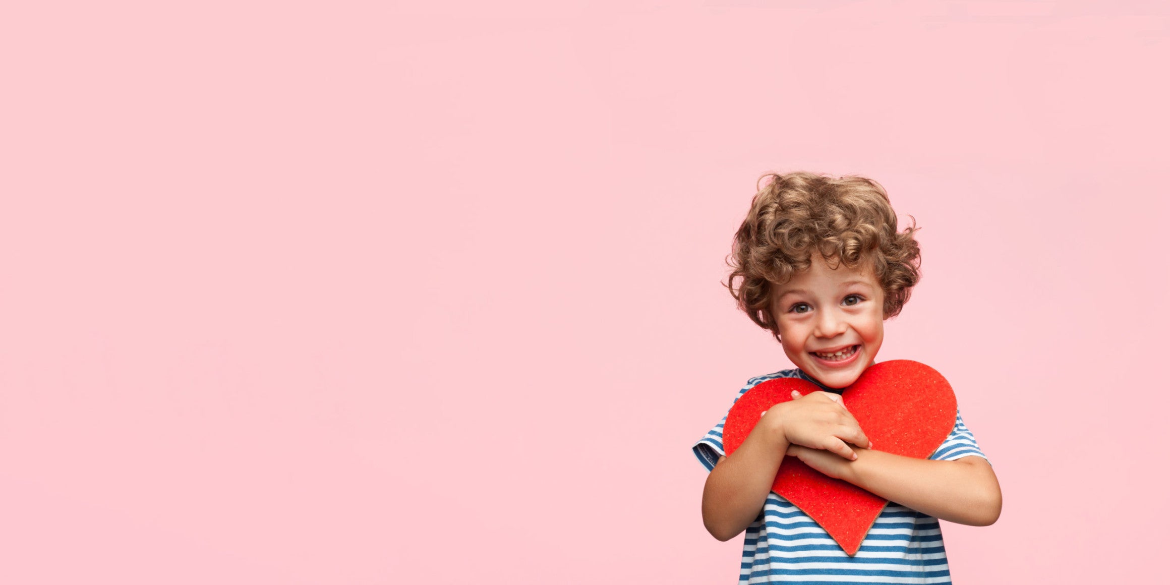 Charming boy posing with heart