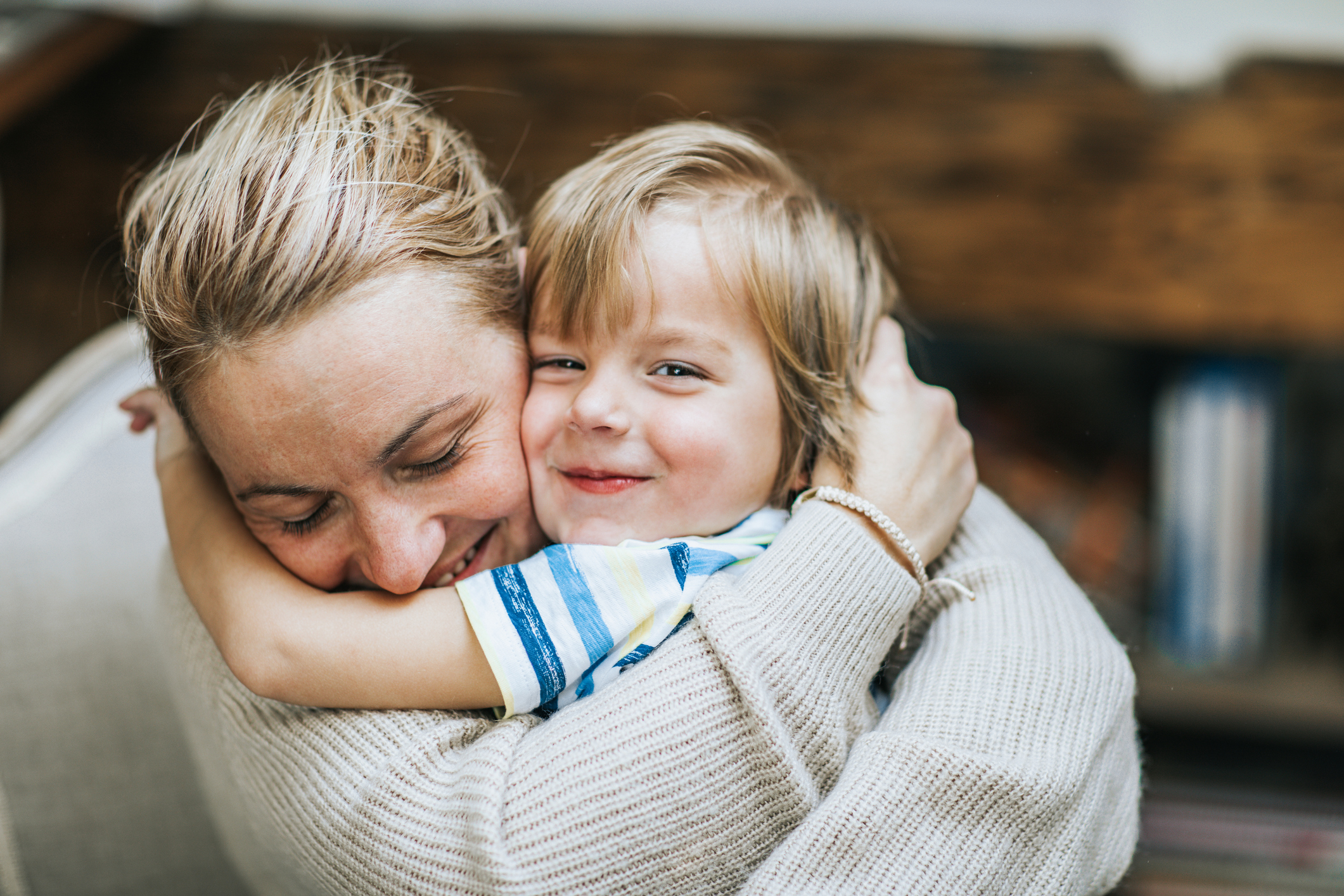 Affectionate Mother And Son Embracing At Home 